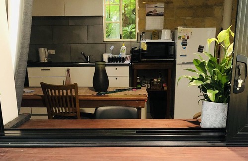 Bonny Hills Condo | Pet friendly covered courtyard with private studio