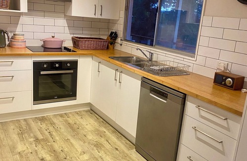 Moruya Heads House | “Southerly Change”. Groovy retro/modern Beach House. Bring your surfboard & dog!