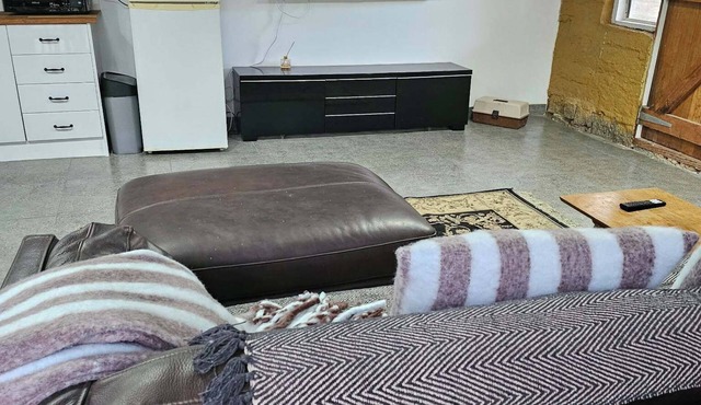 Mudbrick self contained studio with wood heater