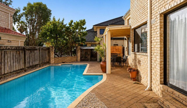 Spacious, sun-drenched 5-bedroom home in prime Applecross. Featuring a private pool, indoor pool table, secure outdoor spaces, and high ceilings, this retreat is designed for unforgettable family memories by the river.